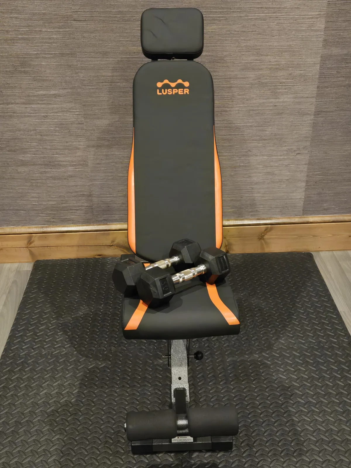 A dedicated exercise room featuring a weight bench and dumbbells, with ample space for strength training and fitness routines. The setup is clean and motivates guests to pursue their wellness goals.