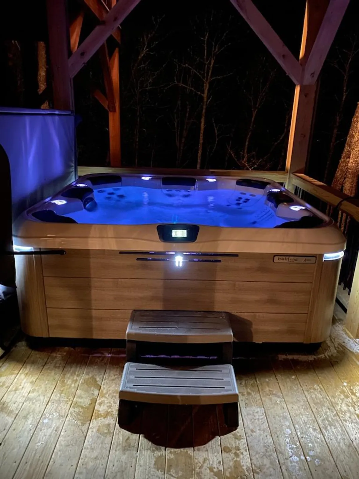 A hot tub set on a wooden deck, surrounded by the serene natural environment. The setting feels private yet spacious—perfect for relaxing evenings under the stars or socializing after a day's adventure.